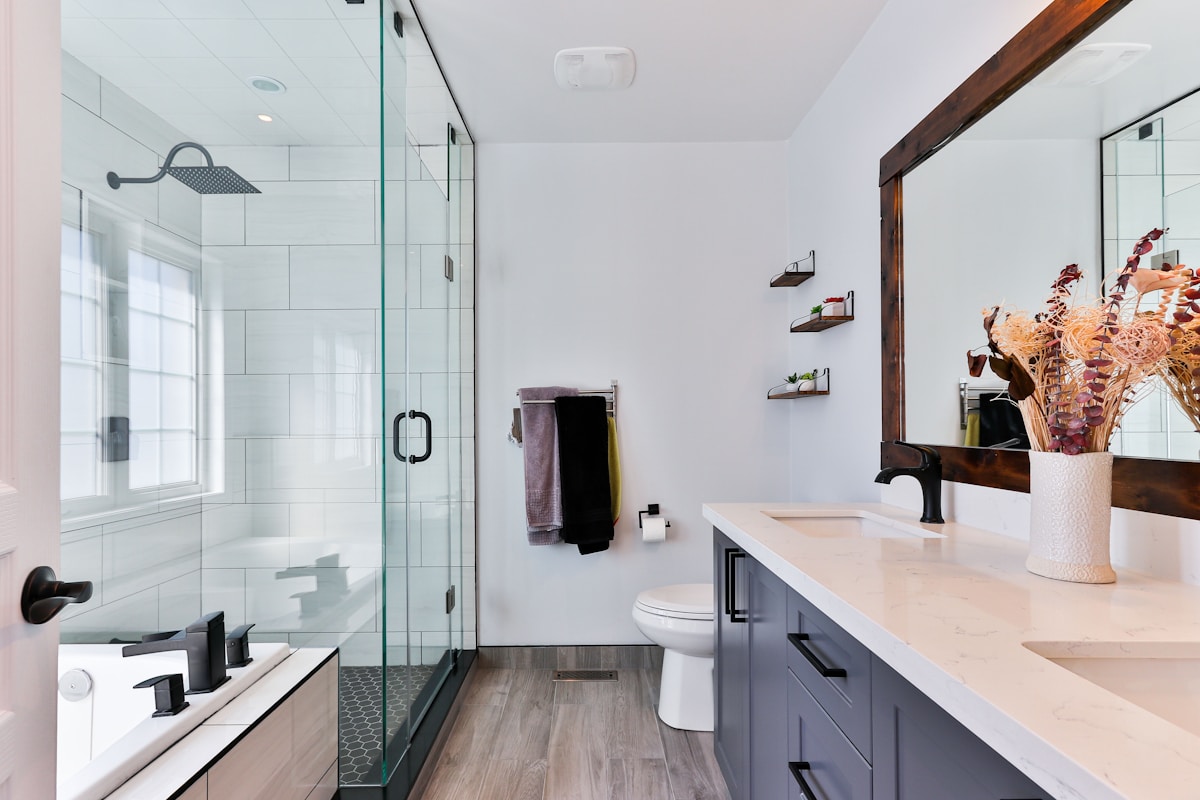 Detail deep clean of gleaming modern bathroom with polished chrome fixtures and marble